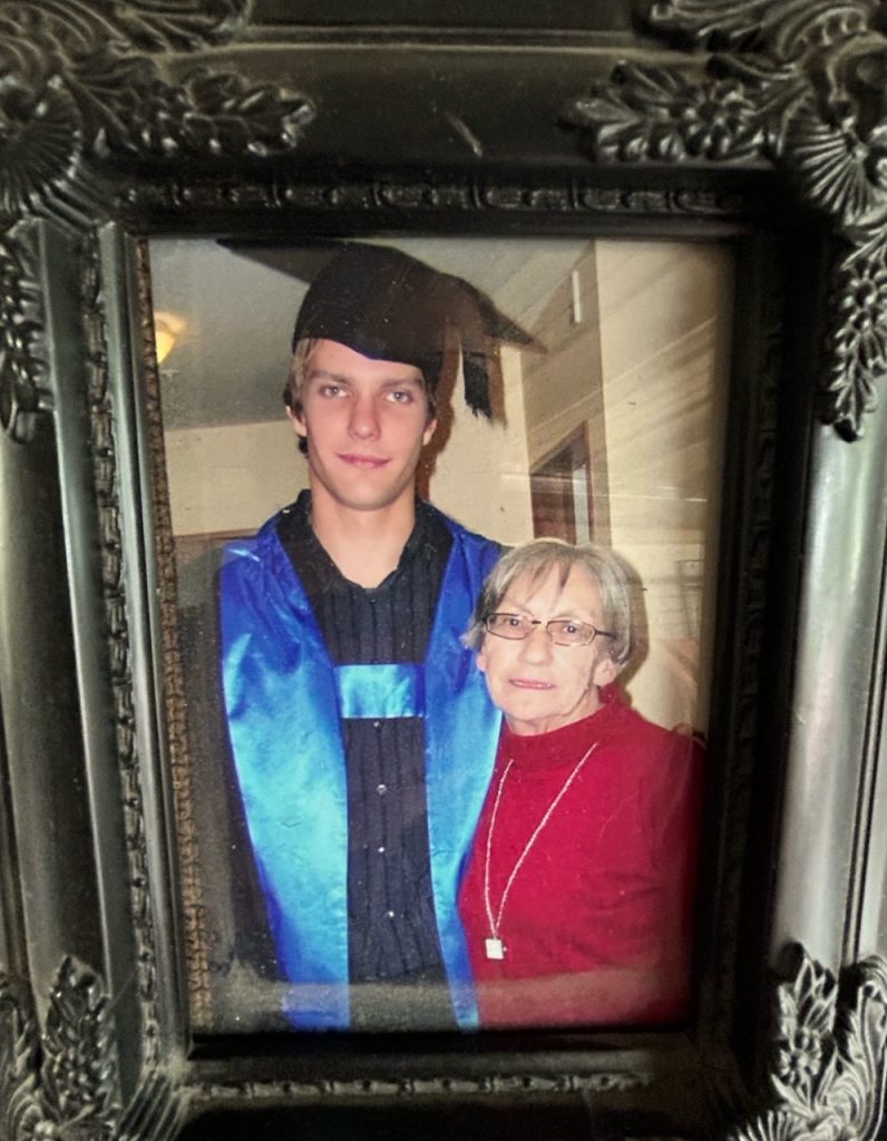 Framed graduation photo of audiologist Sam Sloane pictured alongside his grandmother.